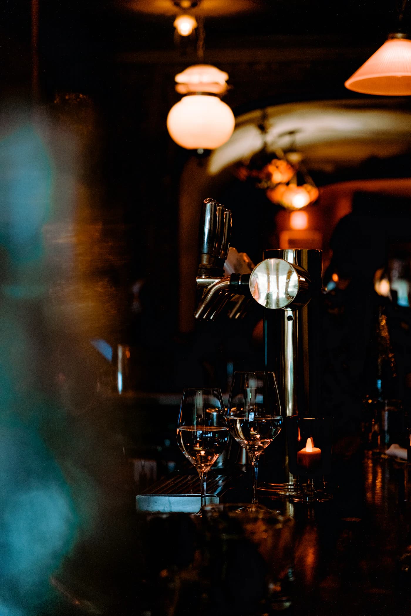 Wine glasses on a warmly lit bar